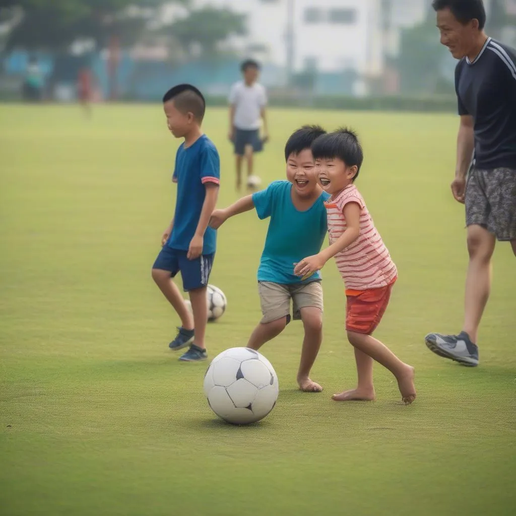 Gia đình cùng nhau chơi bóng đá tại sân vận động